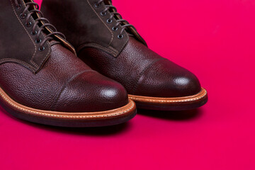 Closeup of Toes of Brown Leather Mens Shoes Over Burgundy Background. - 770485239