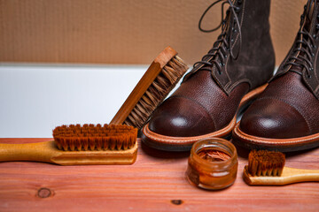 Shoes Cleaning Accessories for Dark Brown Grain Brogue Derby Boots Made of Calf Leather Over Paper Background with Cleaning Tools. - 770486629