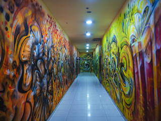 Graffiti walls corridor, tunnel in shopping mall going to the WC, toilets