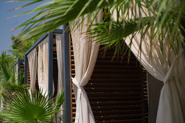 Summer beach gazebos with palm-fringed shores, ideal for resort hotels, tours, cottages, and eco-friendly exploration. Embrace coastal charm and local attractions.