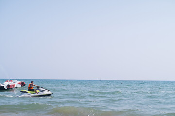 Man in life jacket rides jet ski in the sea, representing extreme sports and guided tours. Experience adrenaline-packed adventures with tourist services.