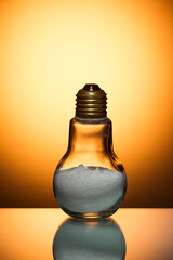 Composite Image of Glass Bulb Lamp Filled with Salt Powder Over Glowing Orange Background