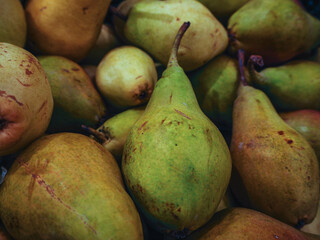 Close up fresh green and yellow pears in supermarket, fruit store