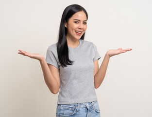 Beautiful smiling happy young asian woman age around 25 in gray shirt. Charming female lady standing pose on isolated white background. Asian woman people looking camera confident with backdrop.