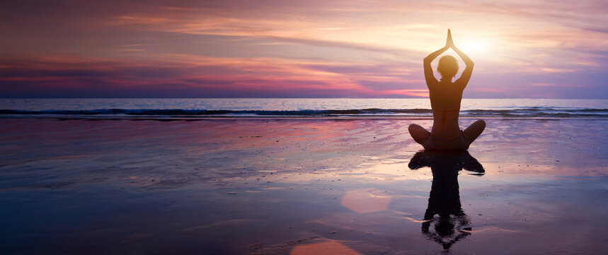 yoga meditation and mindfulness banner background, breathing exercise, silhouette of woman sitting in lotus on the beach with copy space