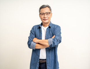 Handsome asian mature old man standing arm crossed on isolated white background. Happy Portrait of cheerful smiling senior asian man looking at camera. Mature People and lifestyle