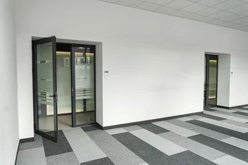 Fotobehang Empty office space With Two Doors and a Checkered Floor © Jelena
