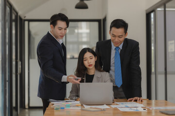 A group of employees happily work together in the office while discussing work that was completed on time as ordered by their boss, A group of entrepreneurs had fun working together.