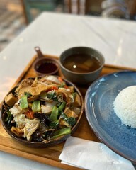 Stir fried chicken with sweet and sour sauce in a bowl on table