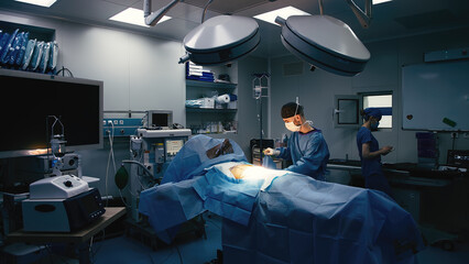 A medical anastasiologist prepares a patient for surgery in a modern operating room. Medical...