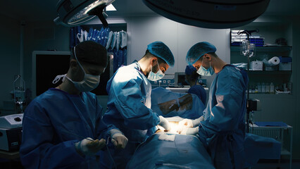 Close-up of surgeons in protective clothing in a modern operating room. Healthcare, surgery and cosmetic surgery concept. - obrazy, fototapety, plakaty