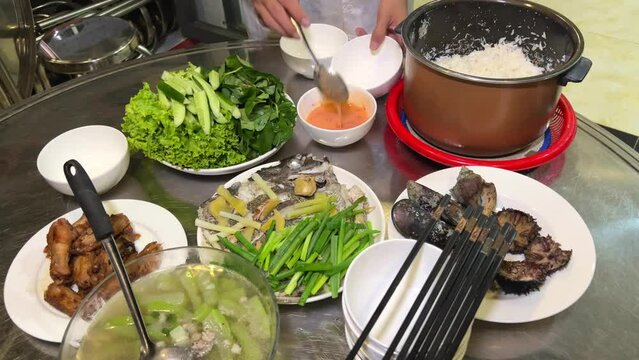 Vietnamese food shells mussels rapan fish cooking Vietnamese soup with green leaves and pieces