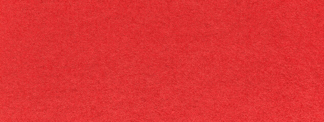 Texture of old bright red color paper background, macro. Structure of a vintage craft scarlet...