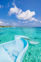 Luxury resort private villa water slide into paradise island lagoon bay. Maldives luxurious...
