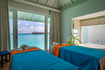 Luxury spa in over water villas. Tropical outdoor design. Idyllic tourism beach scene massage beds...