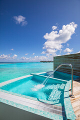 Outdoor resort spa jacuzzi pool with fresh blue water for massage and Spa. Swimming pool at the sea, Maldives luxury over water villas. Sunny tranquil relaxing wellness wellbeing carefree lifestyle