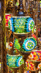 Mosaic of colored glass. Illuminated in the evening, it creates a cozy atmosphere. Vintage multicolored lamps in traditional Oriental style, Arab-style lanterns