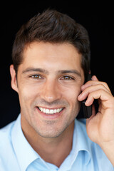 Obraz premium Phone call, smile and businessman in portrait in studio, speaking on mobile conversation, business deal or networking. Consultant or man, communication and connect with smartphone on black background