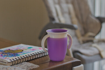 Purple child sippy cup on table