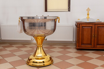 Baptism font with water with towel in an Orthodox church.