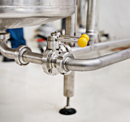 Factory, craft beer and tube for production, manufacturing and metal pipes in industrial workshop. Warehouse, plant or closeup for alcohol, steel and machine for lager, stout and valve in container