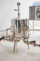 Beer, production and pressure gauge with tank in factory or distillery for winery, alcohol or drink manufacturing. Steel tank or metal container for micro DIY brewery, startup or industry equipment