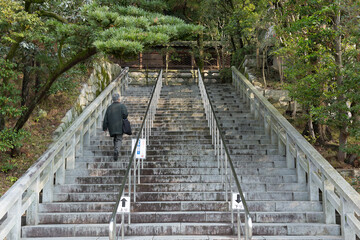Older Japanese Man Walking alone up steps in Kyoto Japan