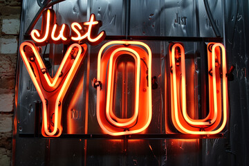 A vibrant neon sign spelling out "Just YOU" glows against a textured metal backdrop