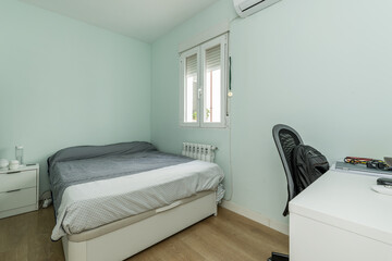 room with double bedroom, bed with square duvet with canape and white desk table