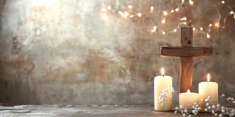 A wooden cross and three lit candles arranged on a table in a neutral background