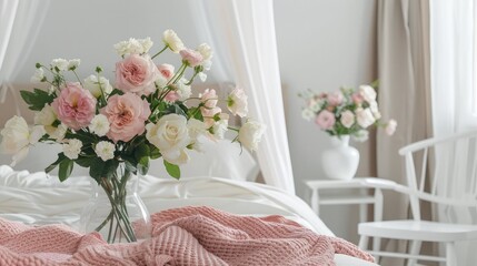 Flowers in vase next to canopy above bed with pink blanket in bedroom with white chair - obrazy, fototapety, plakaty