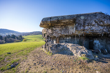 Destroyed entrance and window of the Polish bunker from WW2. Greem meadow in the background during...