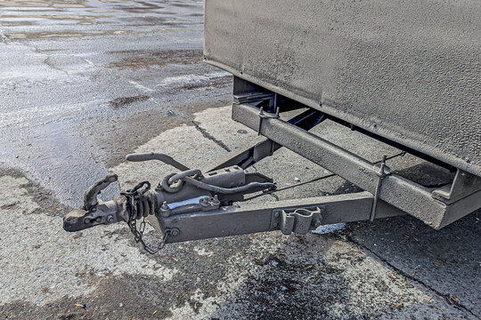 Tow bar of a cargo trailer in the parking lot on a winter day