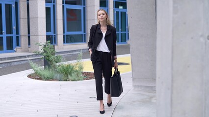 Confident Businesswoman Walking in Urban Setting