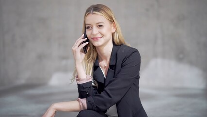 Professional Woman Smiling While Speaking on Phone