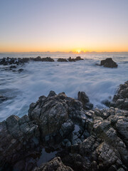Wave water flowing into the coastline in the morning.