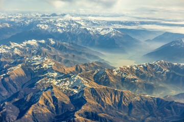 Aerial high altitude view of high peak mountains, Alps, in Switzerland's, Austria, France, Europe...