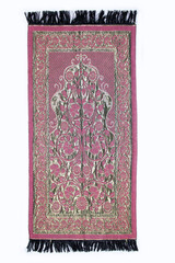 Fototapeta premium A prayer rug used by Muslims for prayer. Isolated prayer rug on a white background.