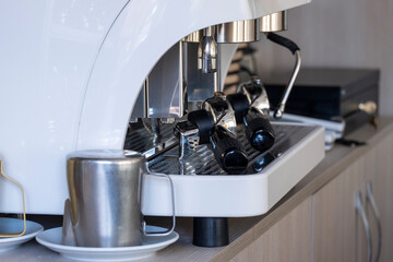 Detail of a professional espresso coffee maker waiting for new customers who want to taste a delicious coffee.
