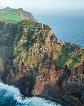 Aerial view of Farol dos Rosais lighthouse and Sao Jorge Island, Azores, Portugal.