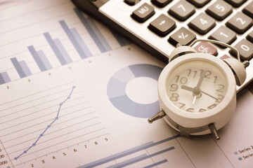 Calculators and alarms placed on financial data reports