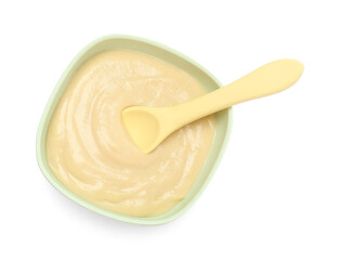 Tasty baby food and spoon in bowl isolated on white, top view