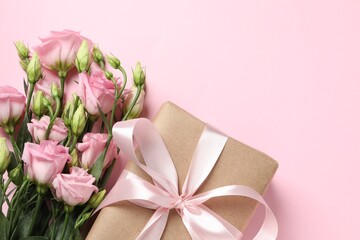 Happy Mother's Day. Beautiful flowers and gift box on pink background, flat lay. Space for text