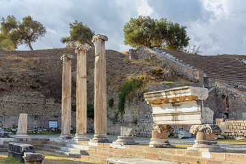 Stoic columns of Asklepieion in Pergamon stand amidst the ruins, blending with the tranquil landscape. Bergama, Izmir, Turkiye (Turkey)