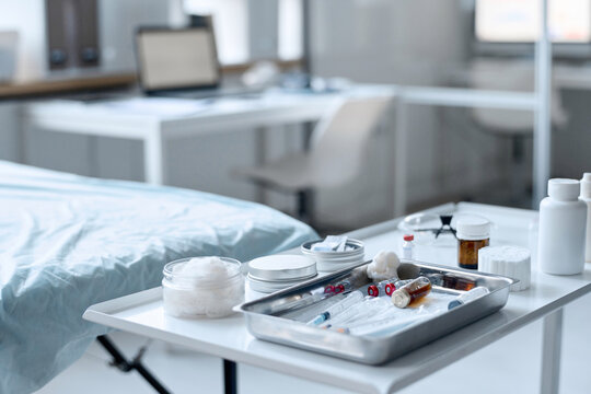 Close up background image of medical dish with vaccine and syringes on table in procedure room copy space