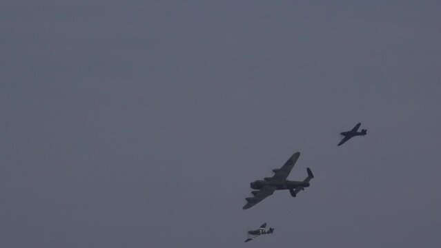 Avro Lancaster bomber world war 2 plane spitfire and Hawker Hunter in formation in the sky. Flying close to camera England UK 4K