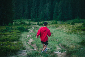 Alone Young Boy Walking in Carpathian Pine Mountains - 770629202