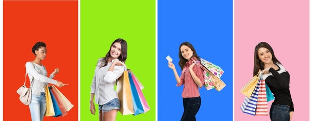 Group of young happy women hold shopping bags