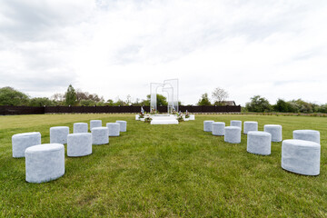 White stools in grassy field