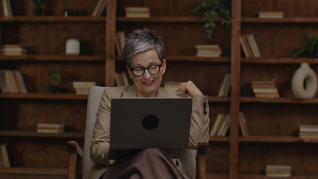 Smiling professional engaging online from her laptop